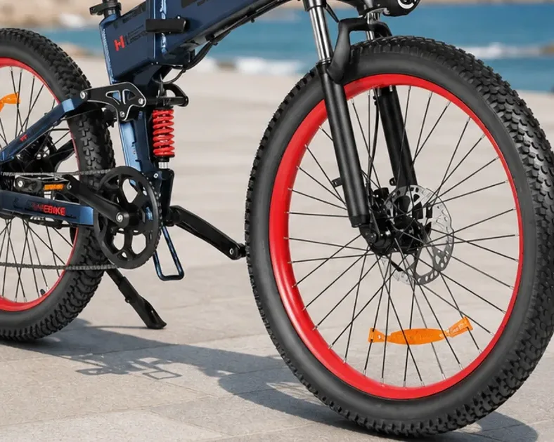 Samebike LO26-II-YD and LO26 Plus folding fat tyre electric bikes parked outside a UK train station.