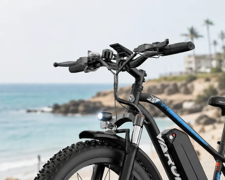 Varun M26-2 PLUS fat tyre electric mountain bike parked on a UK gravel path with green hills behind