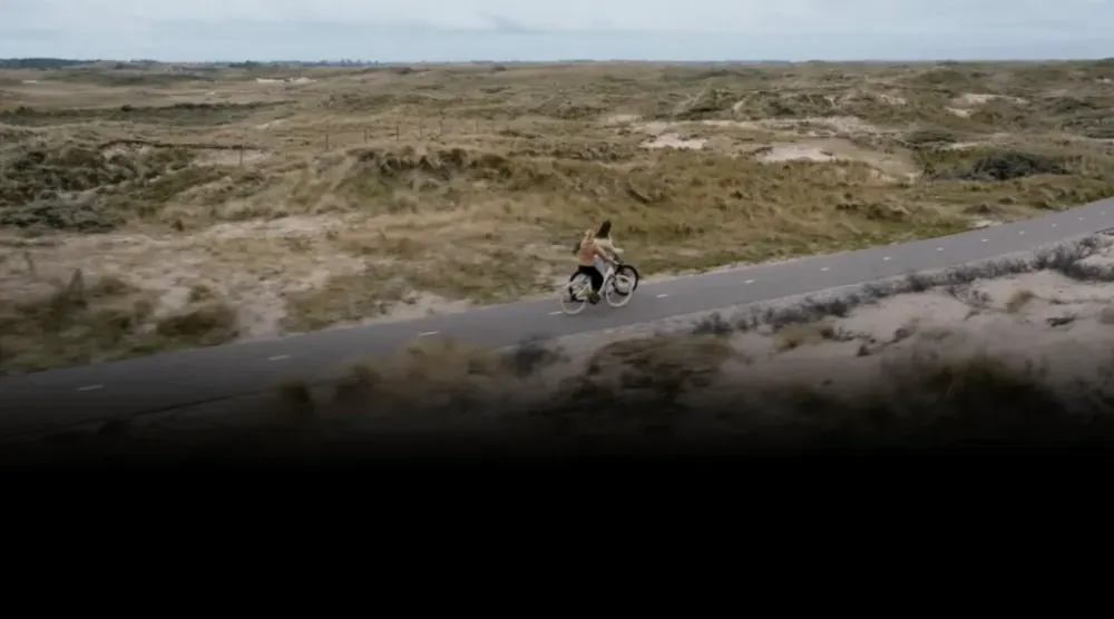 ADO Air 28 removable battery pack being inserted into the downtube, with lock mechanism visible.