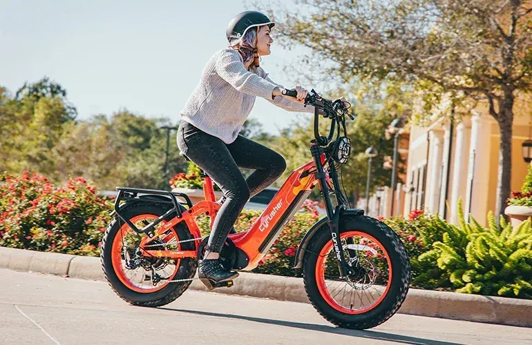 Cyrusher Ovia step-through e-bike in gray, full side view on a city street.