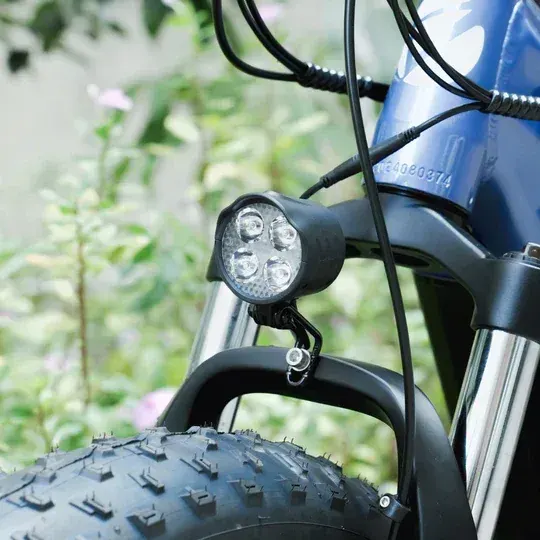 Rider on a Cyrusher Rover e-bike climbing a hill, full suspension active