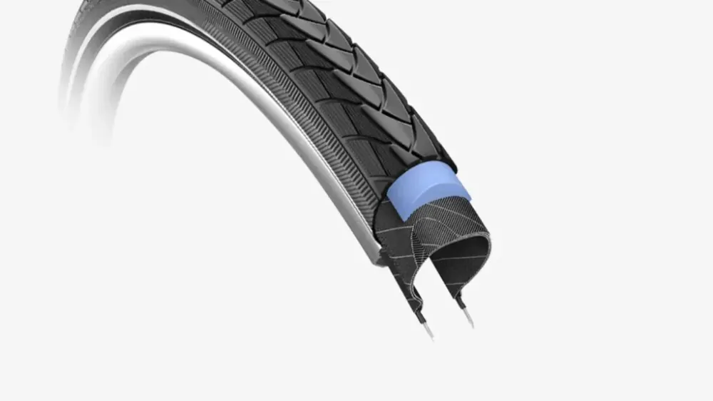 Heybike EC 1 hydraulic disc brake caliper and rotor on front wheel, with silver finish.